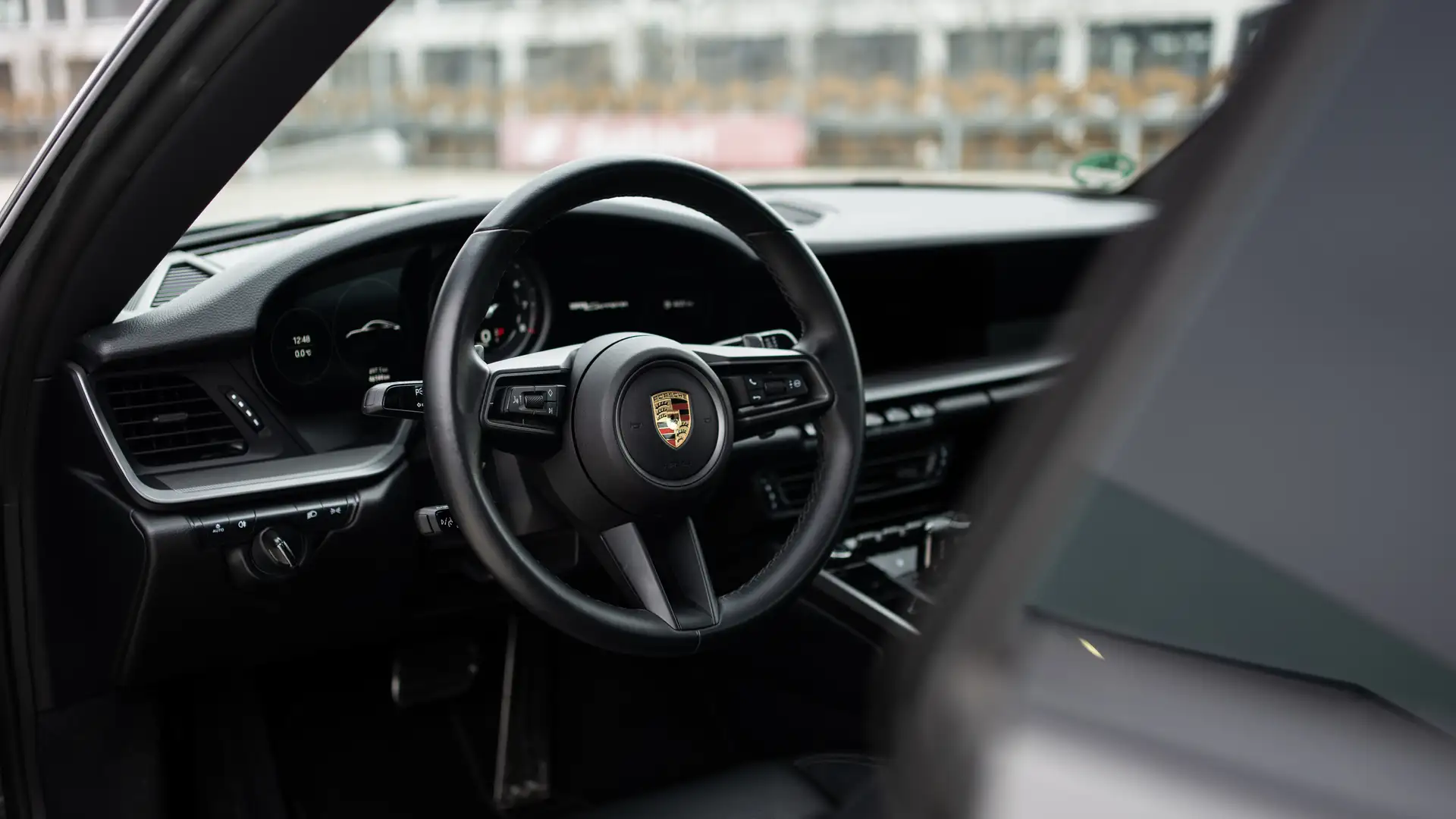 The steering wheel and interior of a Porsche 911 Carrera.